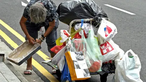 Getty Images Woman cart waste collection Singapore