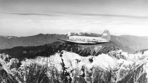 View of a US Army Air Transport Command cargo plane as it flies over the snow-capped, towering mountains of the Himalayas, along the borders of India, China, and Burma, January 1945, February 20, 1945.