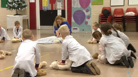 Children learning first aid