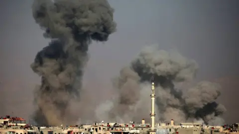 AFP Smoke rises from the town of Arbin, in the rebel-held Eastern Ghouta near Damascus, Syria (7 February 2018)