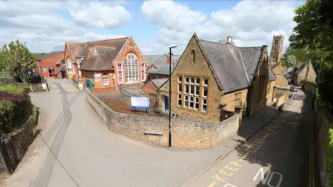 West Northamptonshire Council Stone-built village primary school at road junction
