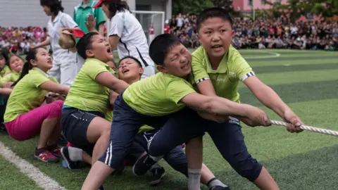 AFP Schoolchildren playing tug-of-war in Pyongyang