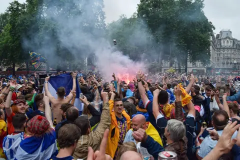 SOPA Images/ PA Media Scotland fans in Leicester Square