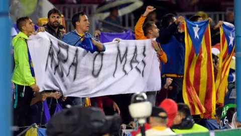 AFP/Getty Images FC Barcelona fans hold a banner that reads "Now or never" during a Champions League match against Olympiakos in Barcelona. Photo: 18 October 2017