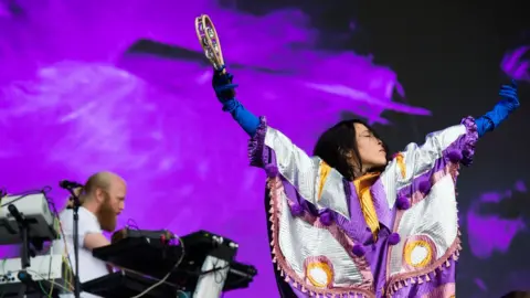 Yukimi Nagano, lead singer of Little Dragon, playing a tambourine