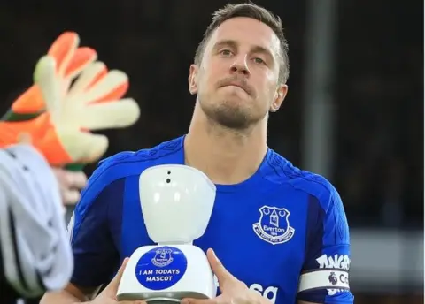 PA Phil Jagielka and the robot mascot