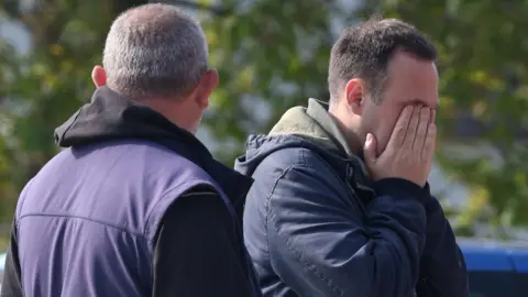 EPA A man grieves in the village Dubona after the attack.