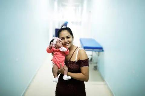 Nacho Doce/REUTERS Irene, 23, a Venezuelan woman from Santa Elena city, holds her six-day-old baby Ashlei at a maternity hospital in Boa Vista, Roraima state, Brazil 21 August 2018