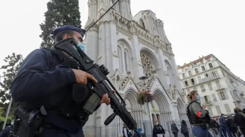 EPA Police officers stand outside the Notre Dame church in Nice