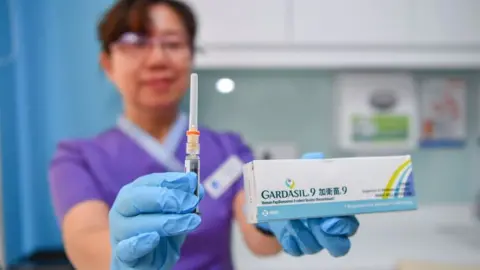 Getty Images A doctor in China holding the Gardasil box