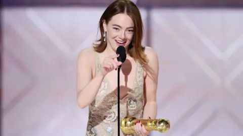 Getty Images Emma Stone accepts the award for Best Performance by a Female Actor in a Motion Picture Musical or Comedy for "Poor Things" at the 81st Golden Globe Awards held at the Beverly Hilton Hotel on January 7, 2024 in Beverly Hills, California