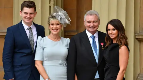 AFP Eamon Holmes with his wife and children