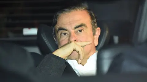 Getty Images Former Nissan chairman Carlos Ghosn leaves his lawyers' offices after he was released earlier in the day from a detention centre after posting bail in Tokyo on March 6, 2019