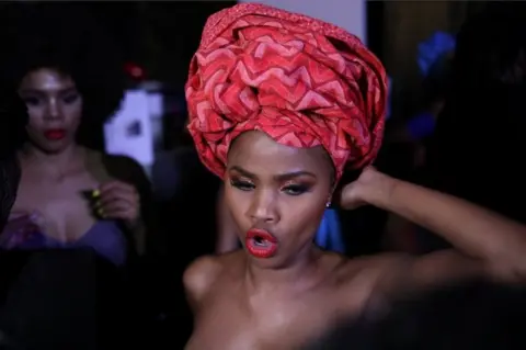 Reuters A model waits backstage before participating in AFI Joburg Fashion Week show with the theme #AfroAsia, in Johannesburg, South Africa, in this photo released on 6 October.