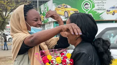 Passengers arriving from Tigray are greeted by relatives at the Bole International Airport in Addis Ababa on December 28, 2022