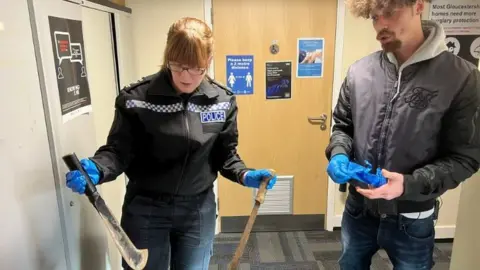 Police officer and man look at knives