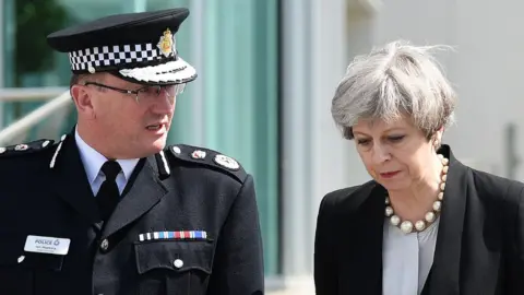 Getty Images Prime Minister Theresa May (R) walks with Chief Constable of Greater Manchester Police, Ian Hopkins