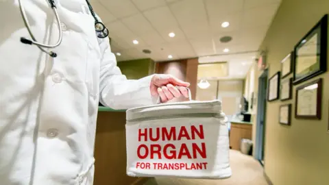 Getty Images Medic holding a bag marked 'human organ'