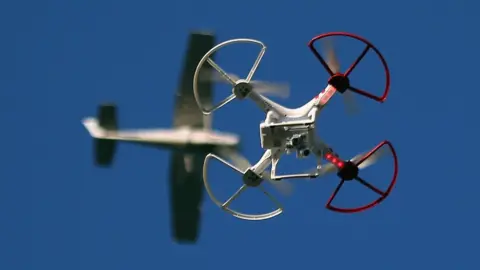 Getty Images Drone with aircraft in background