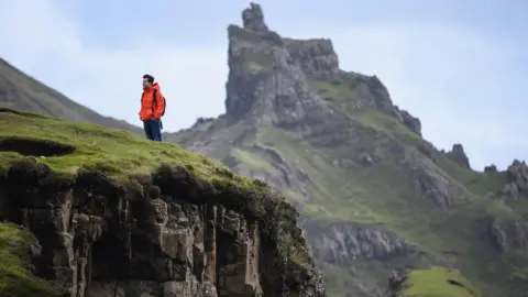 Getty Images A tourist visiting the Quiraing in 2017