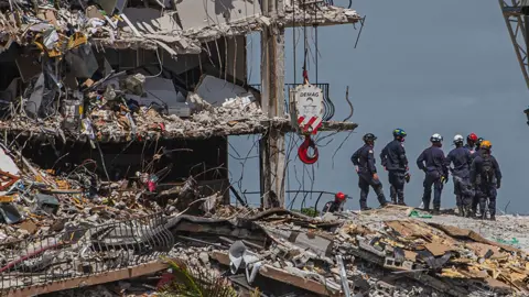 Getty Images Search and rescue teams amid the rubble of the collapsed building