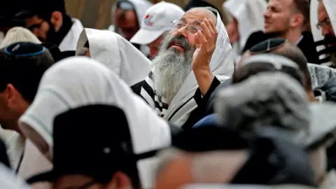 Getty Images Jewish priests wearing "Talit" prayer shawls take part in the Cohanim prayer (priest's blessing) during the Passover (Pesach) holiday at the Western Wall in the Old City of Jerusalem.