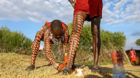 Daniel Irungu/EPA Members of the Maasai community paint their legs for the inaugural Maasai Cultural Festival at the Sekenani village, Kenya - Saturday 10 June 2023