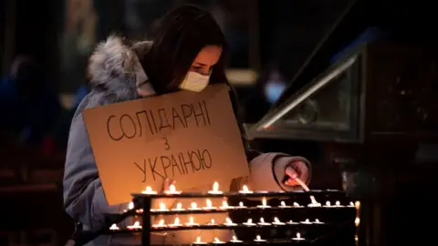 PA Media People gathered at St Mary's Cathedral in Edinburgh to light candles after the Russian invasion of Ukraine.