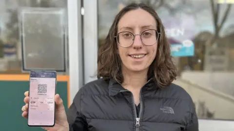 BBC Jenna Blackburn holding her train ticket