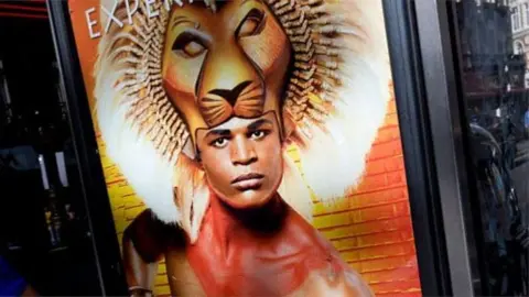 Getty Images Andile Gumbi on poster for The Lion King musical