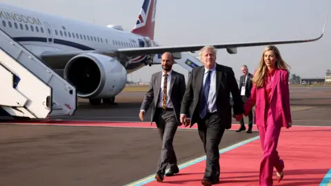 Reuters Boris and Carrie Johnson arrive in Rwanda