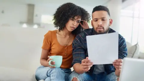 Getty Images Image of couple looking at bill