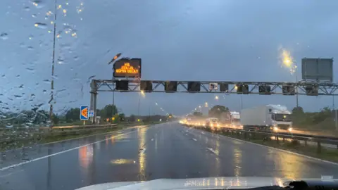 CMPG Flooded motorway seen from police car passenger window