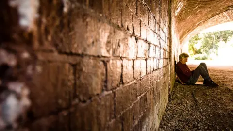 Getty Images Homeless man in tunnel