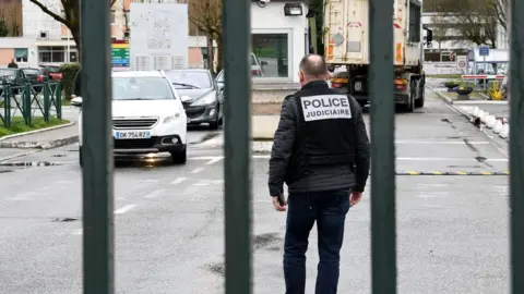 AFP/Getty Police stand guard at entrance to 7th CBA de Reynies barracks