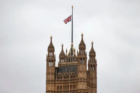 Getty Images A union jack flies at half mast from the top of Victoria Tower at the Palace of Westminster