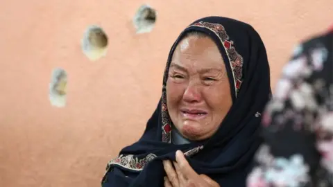 Reuters An Afghan woman cries while looking for her relative at a hospital which came under attack yesterday in Kabul, Afghanistan May 13, 2020.