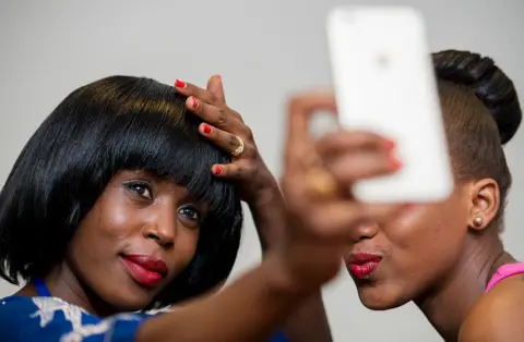 AFP Two women pose for a selfie before Swahili Fashion Week in Dar es Salaam, Tanzania on 4 December 2015.