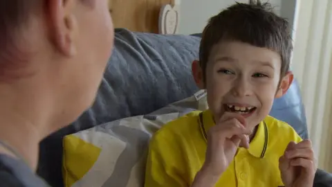 Jensen signing with his mum, Gillian Douglas-Rea