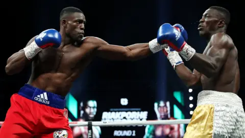 British cruiserweight Richard Riakporhe (left) lands a punch on Nigeria's Olanrewaju Durodola (right)