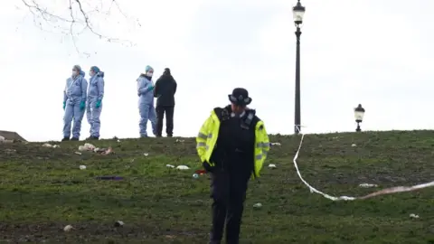 PA Media Police officers in forensic suits on Primrose Hill, Camden
