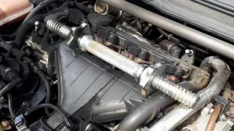 NSRAPT Dumbbell on top of part of engine