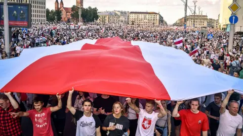 Getty Images Opposition supporters hold a flag in opposition to the government