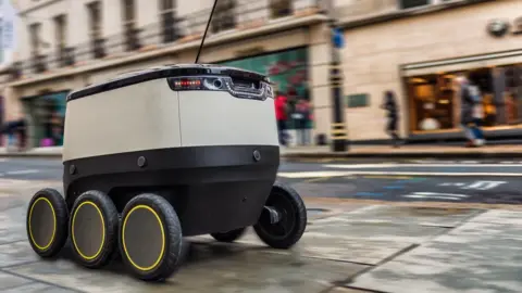 SIMON BIRT Self-driving robot navigating a London street