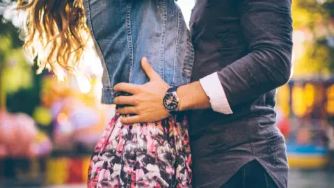 Getty Images Couple kissing in street