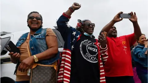 People cheer as Biden arrives in Greenwood