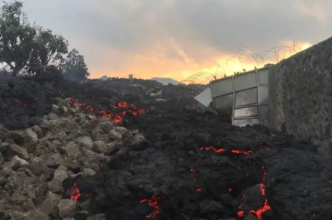 AFP Smouldering ashes are seen early morning in Goma in the East of the Democratic Republic of Congo on 23 May 2021 following the eruption of Mount Nyiragongo