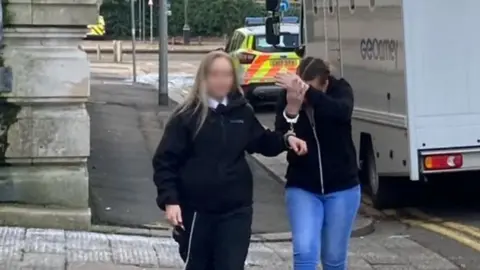 BBC Rebecca Press and a court officer arriving at Cardiff Court