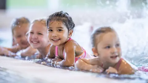 Getty Images children swimming in pool