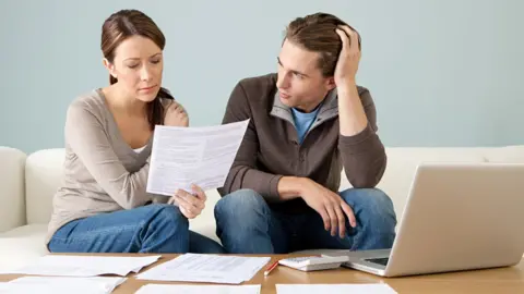 Getty Images Couple looking at bills